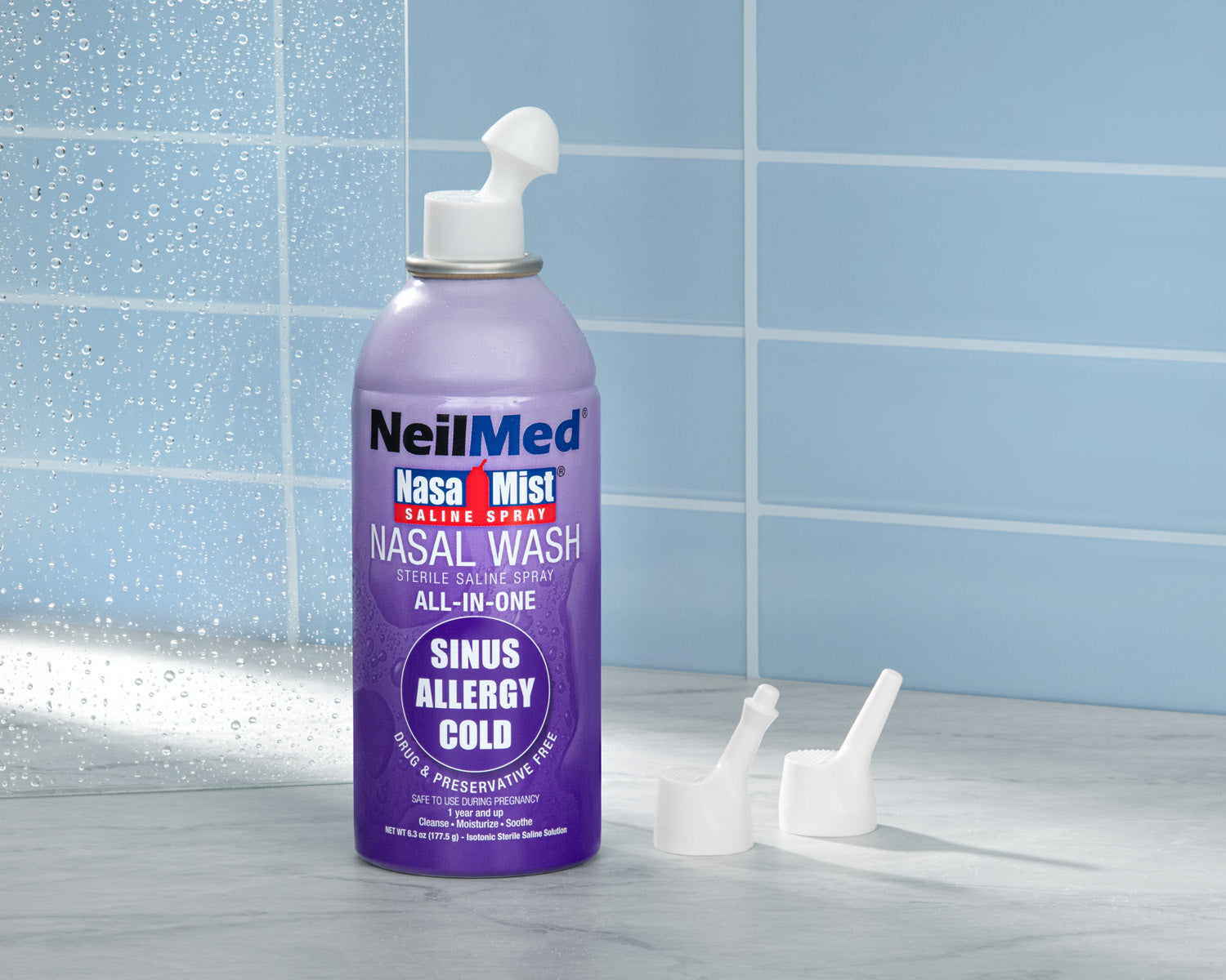 Purple NeilMed Nasal Mist bottle on a tiled bathroom floor