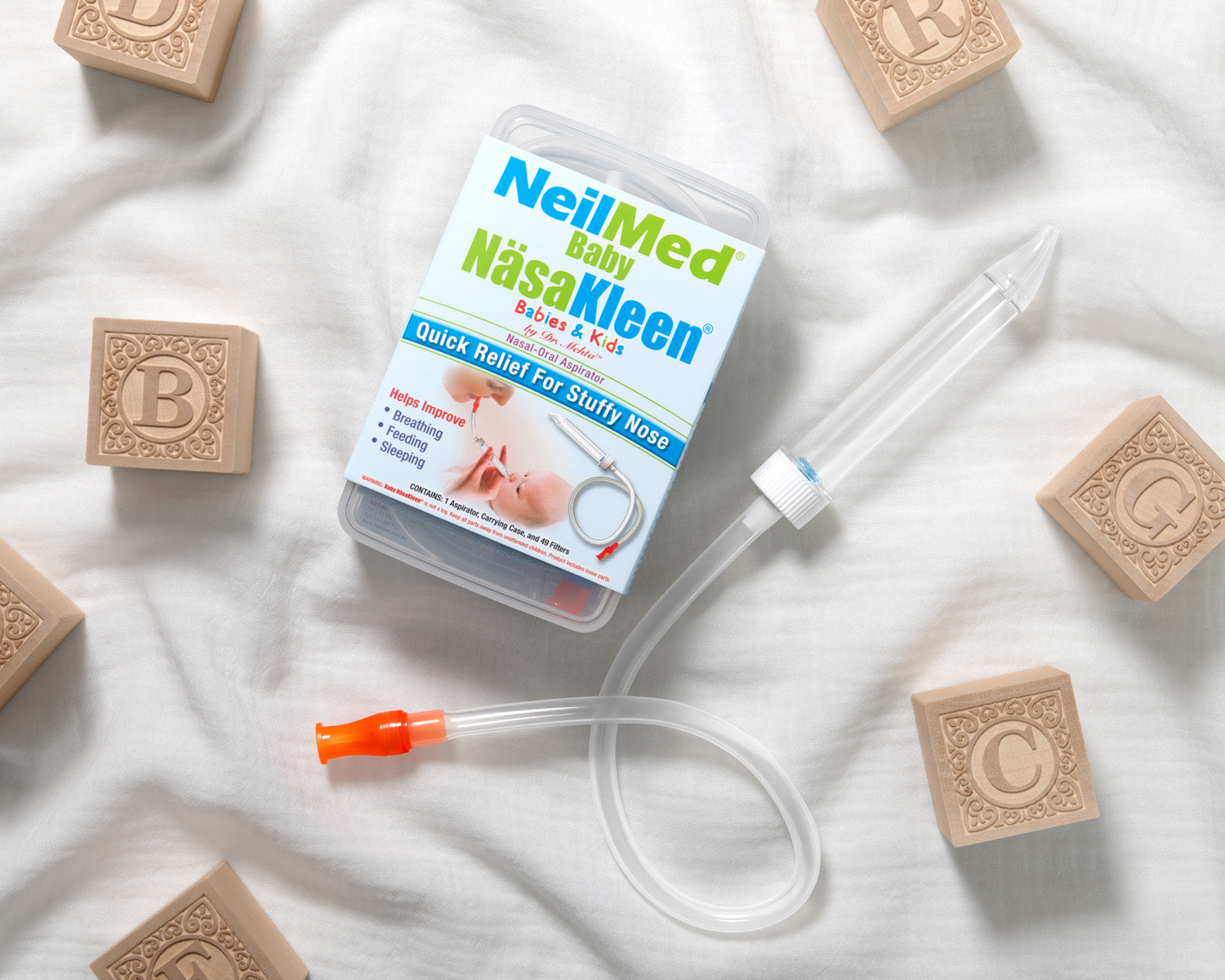 NeilMed NäsaKleen device with packaging on a white background surrounded by blocks