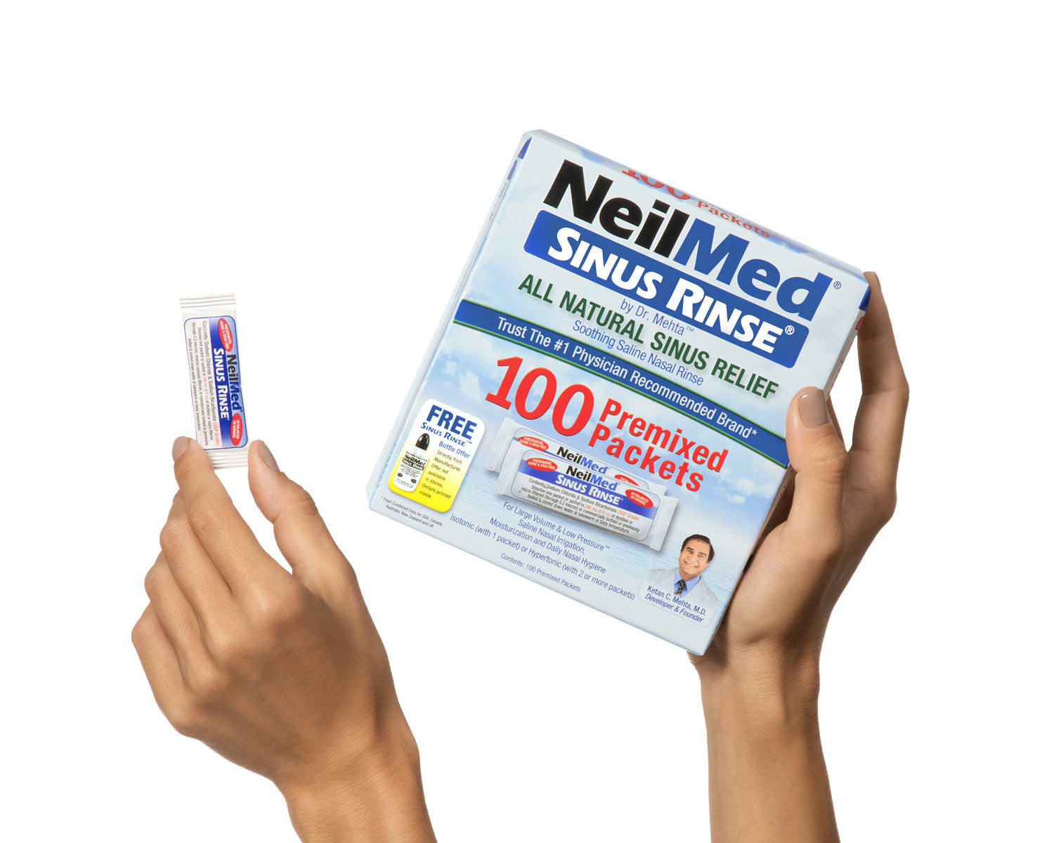 Box of NeilMed Sinus Rinse packets held by hands on a white background