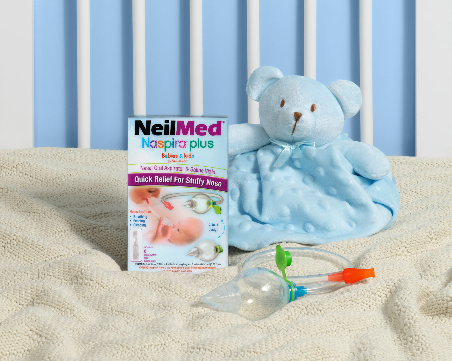 NeilMed Naspira plus packaging with a blue teddy bear and suction device on a blanket.
