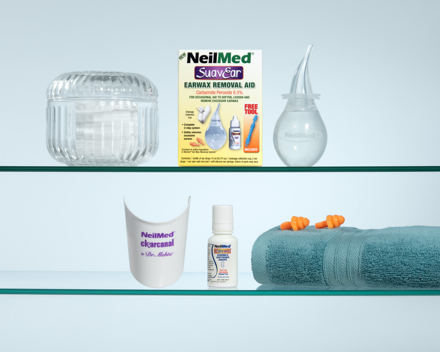 Shelf with NeilMed earwax removal products including a jar, box, and bottles on a light blue background.