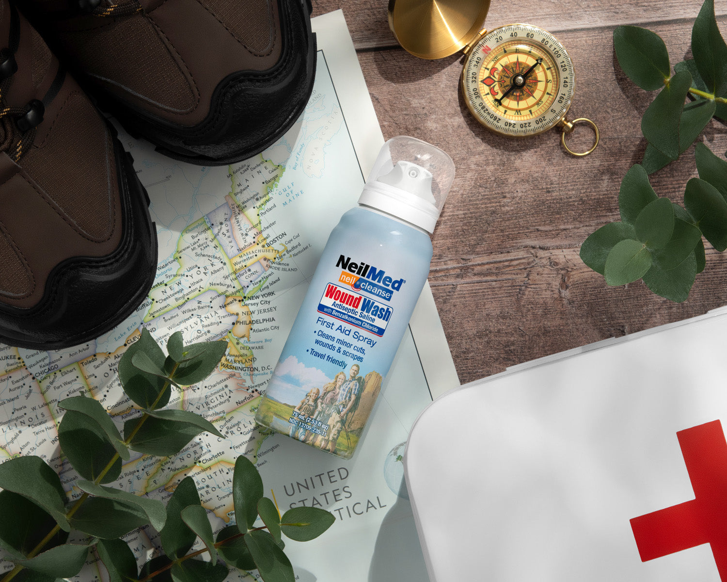 NeilMed Wound Wash bottle on a map with shoes and compass
