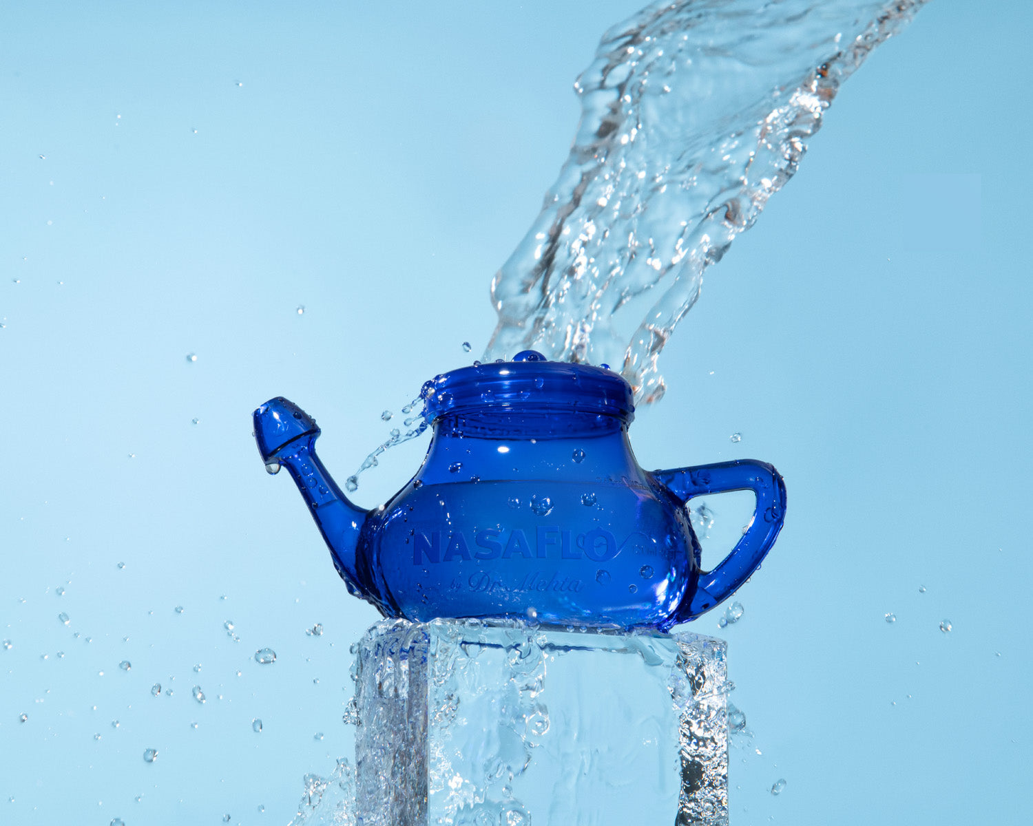 NasaFlo Neti Pot clear blue plastic with water pouring on top